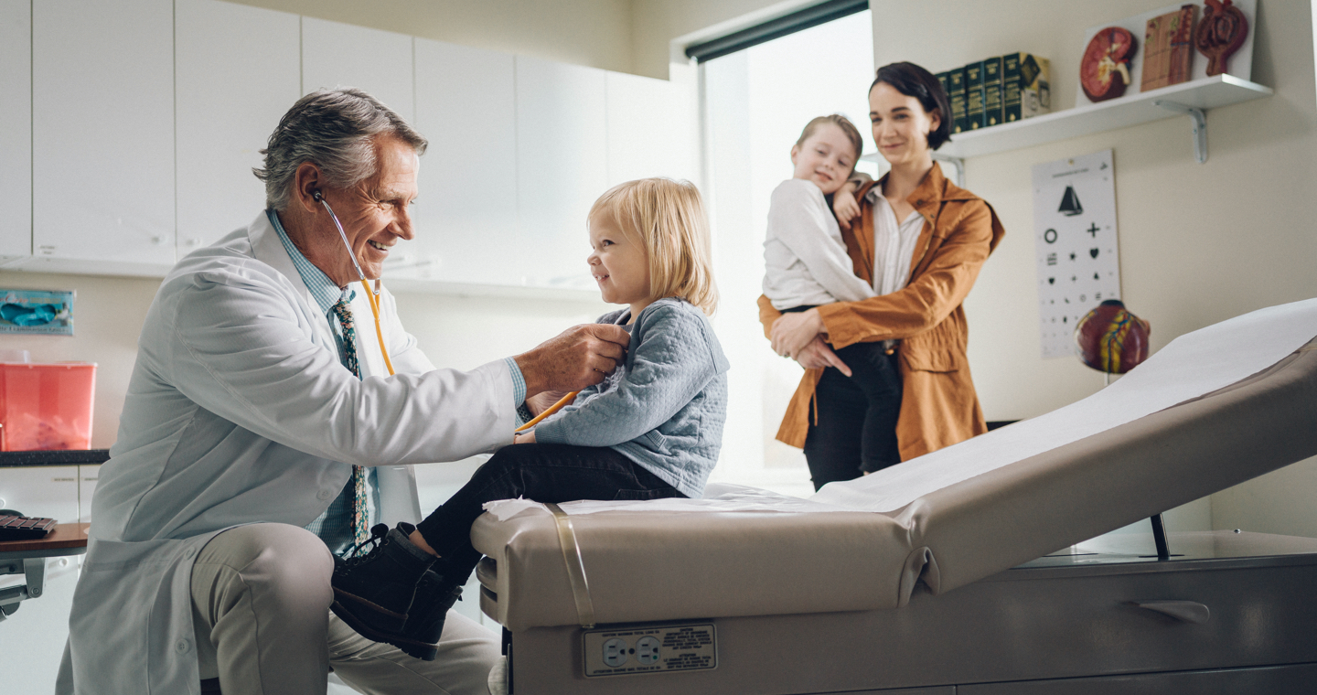 Doctor working with family in office