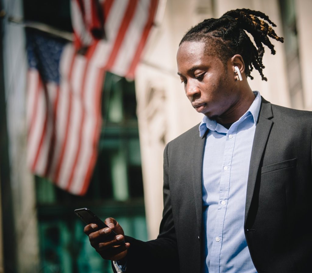 man in suit looking at phone