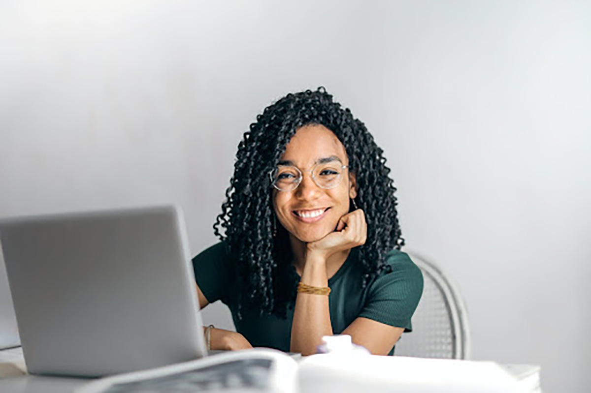 young black woman at laptop smiling