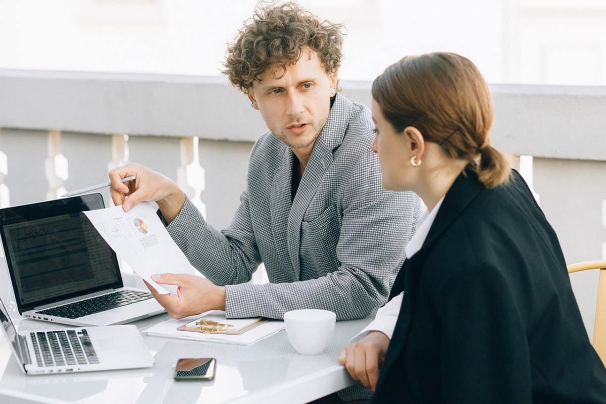 man and woman working on SMS Queue Management Systems