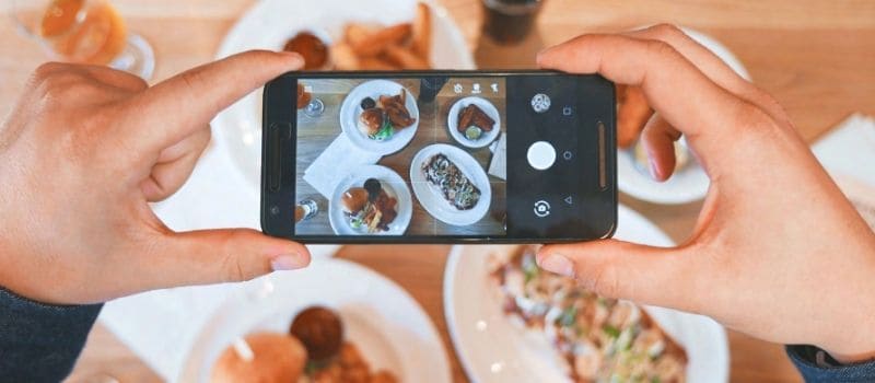 Taking photos of food in front of them