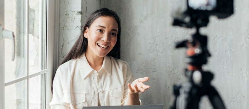 Woman recording herself with a camera