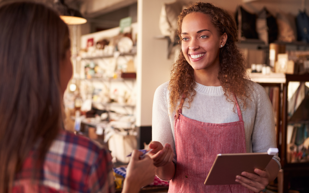  woman taking payment from a customer